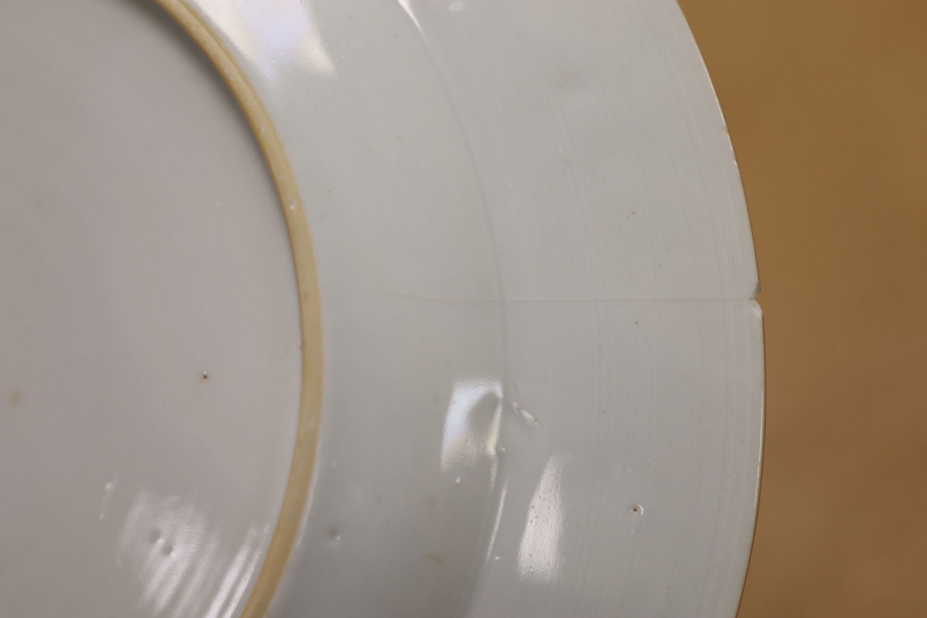 A pair of 18th century Chinese famille rose plates and another similar, largest diameter 22.5cm (damage)